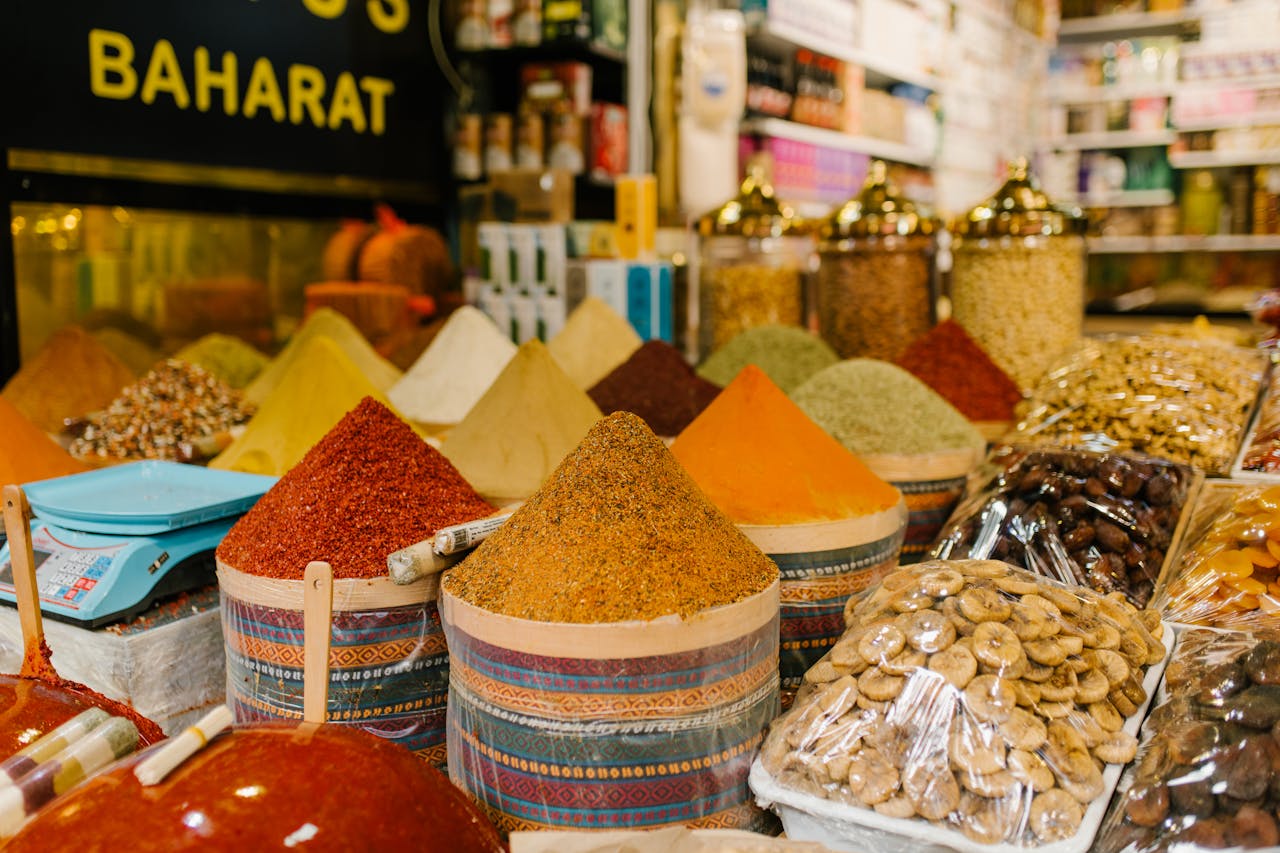 Colorful display of spices and dried fruits at a busy Istanbul market.